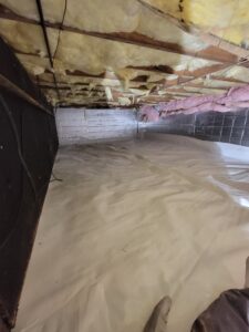Crawlspace encapsulation with heavy-duty liner covering the floor, insulated walls, and sealed foundation, demonstrating effective moisture control for improved home health and energy efficiency.