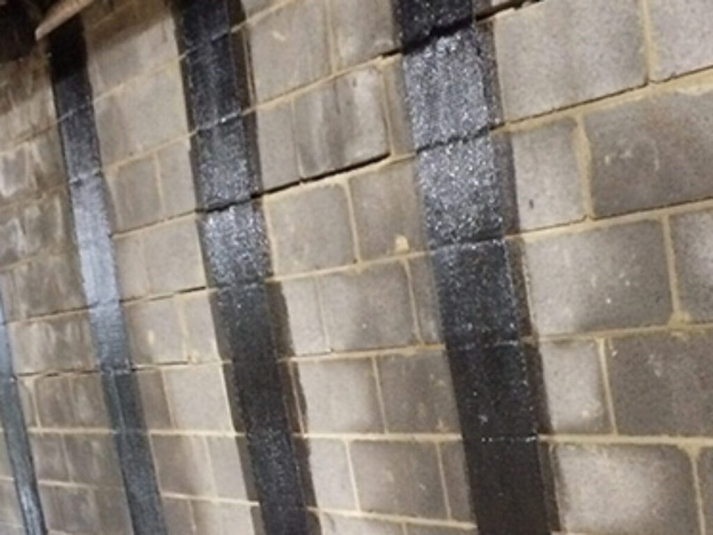 Bowing basement wall in Maryland showing horizontal structural movement and inward pressure caused by expansive clay soil.